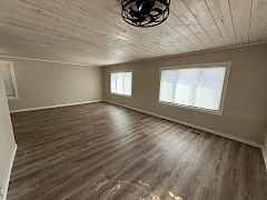 Large living room windows for lots of natural light, whitewashed wood t&g ceilings. Large living room windows for lots of natural light, whitewashed wood t&g ceilings.
